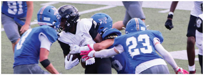 A football player wearing a blue and white uniform. Description generated by AI
