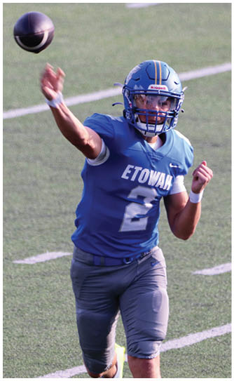 A football player catching a ball. Description generated by AI