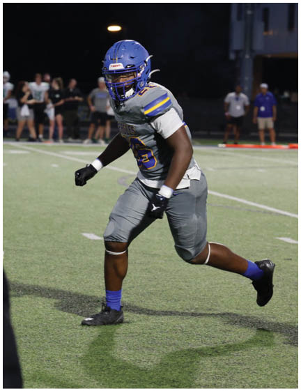 A football player wearing a blue jersey with the number 58 on it. Description generated by AI
