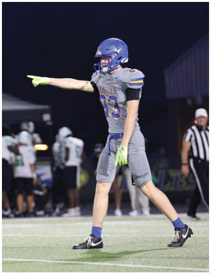 A football player wearing a blue jersey with the number 58 on it. Description generated by AI