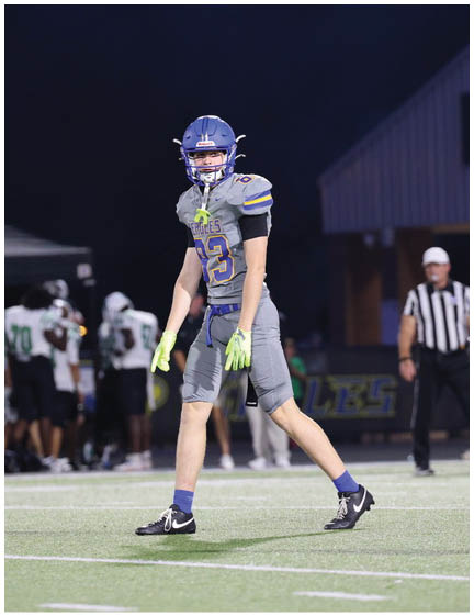 A football player wearing a blue jersey with the number 58 on it. Description generated by AI