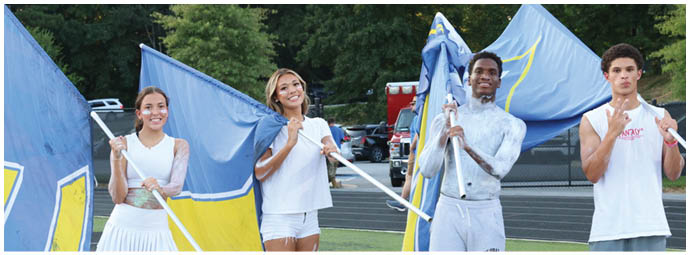 A football player wearing a blue and white uniform. Description generated by AI