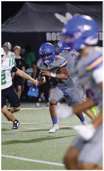 A group of football players wearing black and white uniforms. Description generated by AI