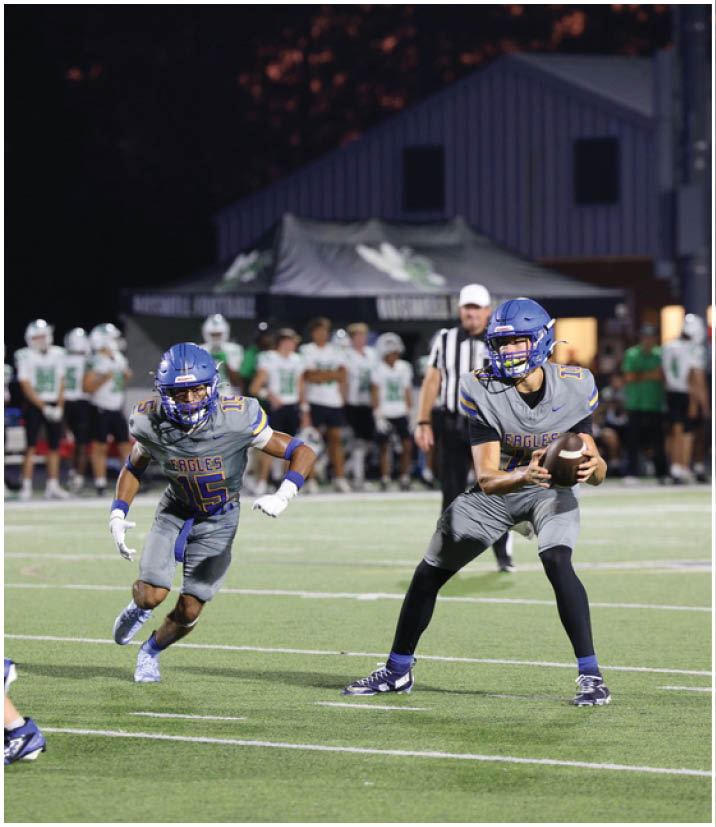 A group of football players wearing black and white uniforms. Description generated by AI
