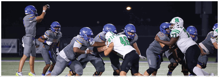A group of football players on a field. Description generated by AI
