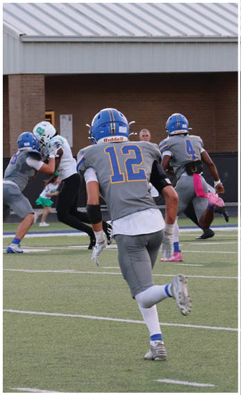 A group of football players wearing black and white uniforms. Description generated by AI