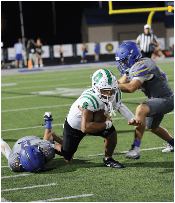 A group of football players wearing black and white uniforms. Description generated by AI
