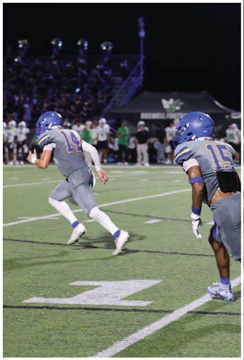 A football player running on the field. Description generated by AI