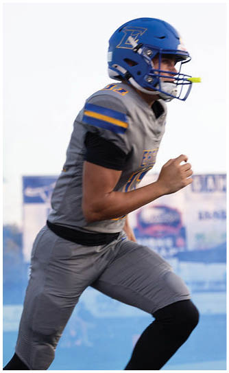 A football player catching a ball. Description generated by AI