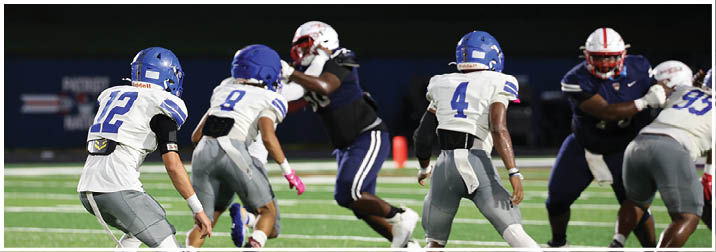 A group of football players on a field. Description generated by AI
