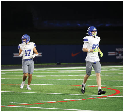 A football player running on the field. Description generated by AI