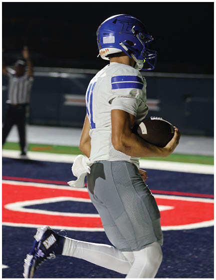 A football player wearing a blue jersey with the number 58 on it. Description generated by AI