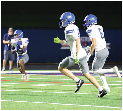 A football player running on the field. Description generated by AI