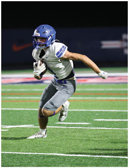 A football player wearing a blue jersey with the number 58 on it. Description generated by AI
