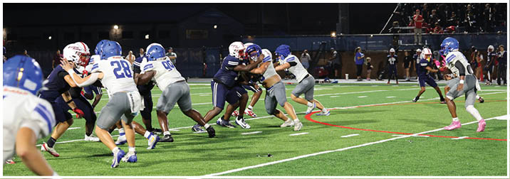 A group of football players on a field. Description generated by AI