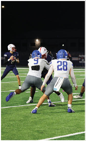 A group of football players wearing black and white uniforms. Description generated by AI