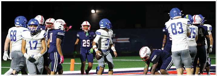 A group of football players on a field. Description generated by AI