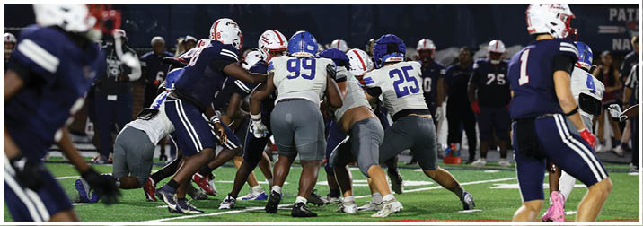 A group of football players on a field. Description generated by AI