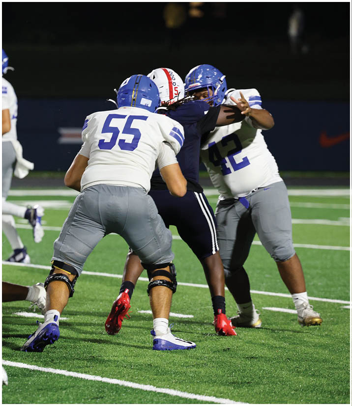 A group of football players wearing black and white uniforms. Description generated by AI