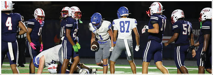 A group of football players on a field. Description generated by AI