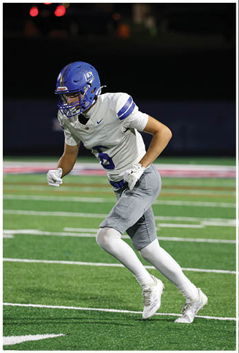 A football player running on the field. Description generated by AI