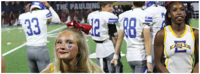 A football player wearing a blue and white uniform. Description generated by AI