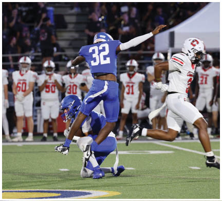 A football player running on the field. Description generated by AI