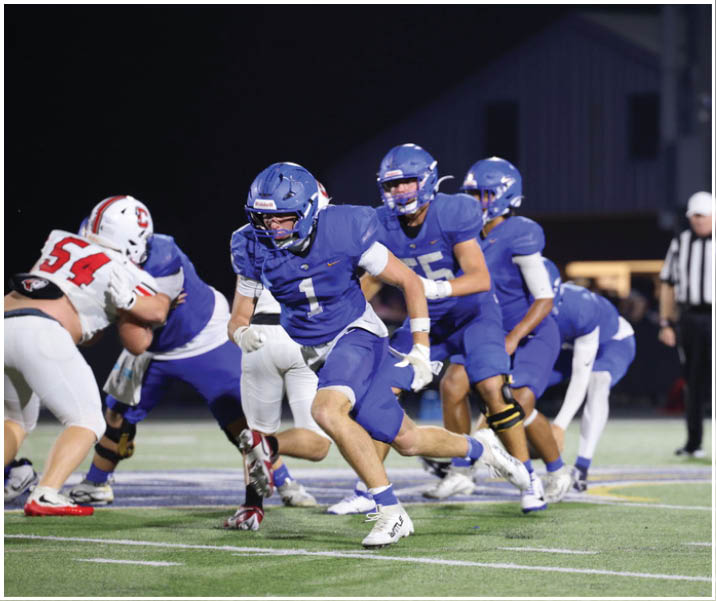 A group of football players wearing black and white uniforms. Description generated by AI