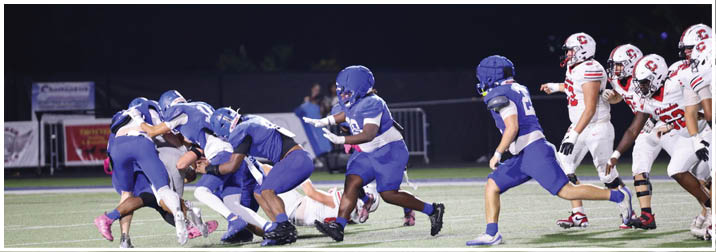 A group of football players on a field. Description generated by AI