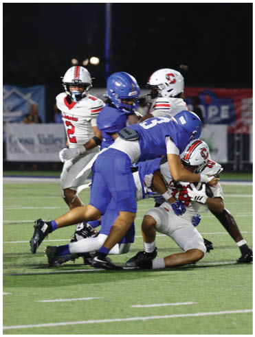 A football player is sliding on the ground. Description generated by AI