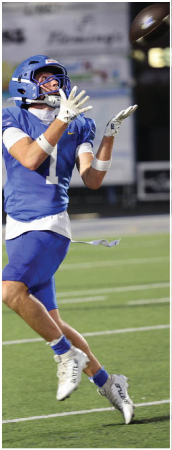 A football player running on the field. Description generated by AI