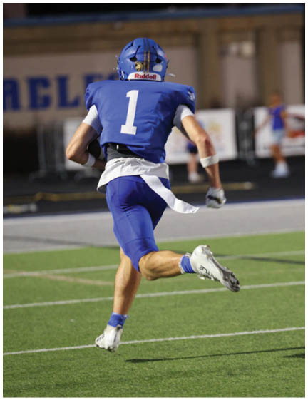 A football player wearing a blue jersey with the number 58 on it. Description generated by AI