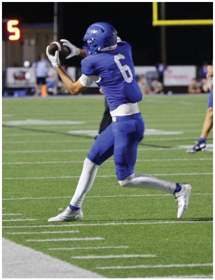 A football player wearing a blue jersey with the number 58 on it. Description generated by AI