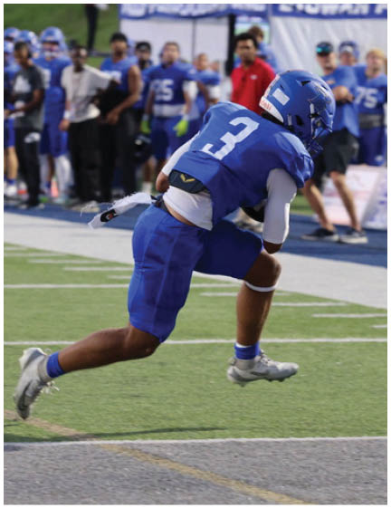 A football player wearing a blue jersey with the number 58 on it. Description generated by AI