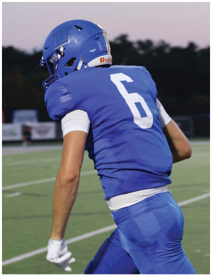 A football player wearing a blue jersey with the number 58 on it. Description generated by AI