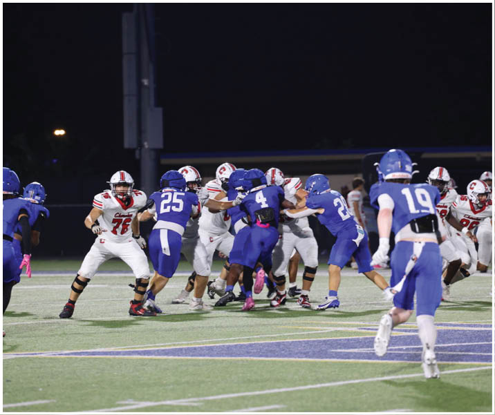 A group of football players wearing black and white uniforms. Description generated by AI