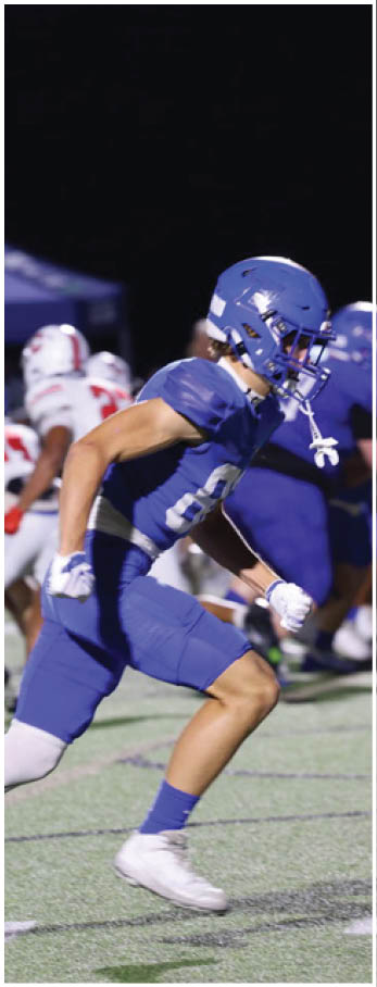 A football player running on the field. Description generated by AI