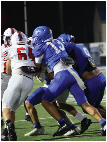 A football player is sliding on the ground. Description generated by AI