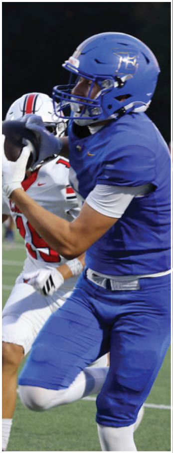 A football player running on the field. Description generated by AI