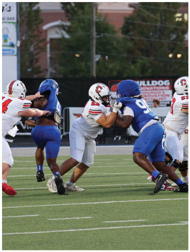 A football player is sliding on the ground. Description generated by AI
