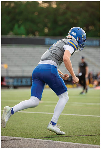 A football game is being played on a field. Description generated by AI