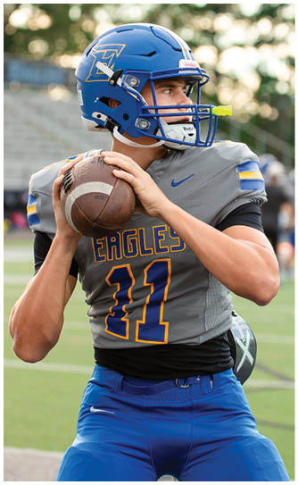 A football player catching a ball. Description generated by AI