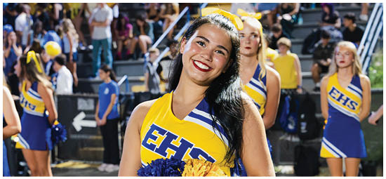 A football player wearing a blue and white uniform. Description generated by AI
