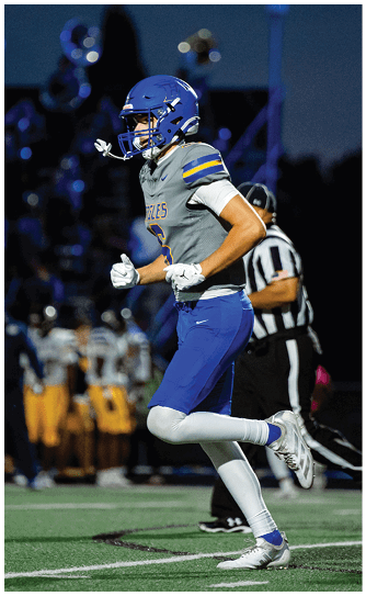 A football player catching a ball. Description generated by AI