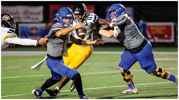 A football player wearing a blue and white uniform. Description generated by AI