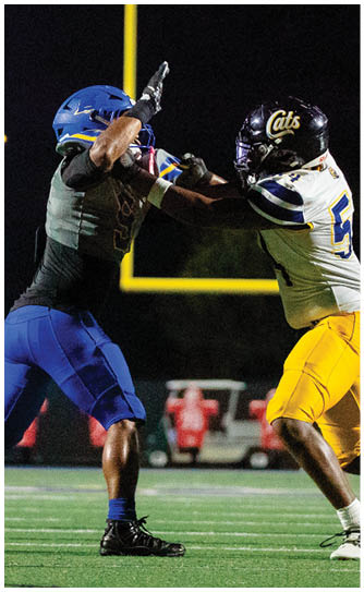 A football player catching a ball. Description generated by AI