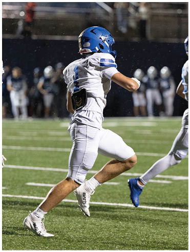 A football player is sliding on the ground. Description generated by AI