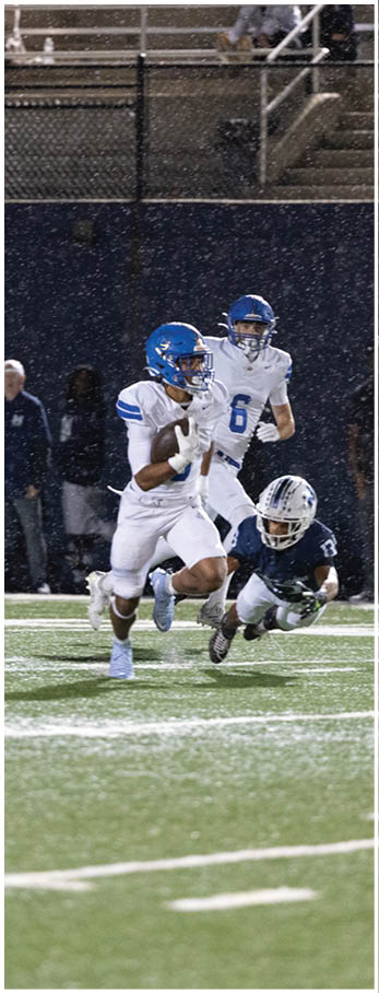 A football player running on the field. Description generated by AI