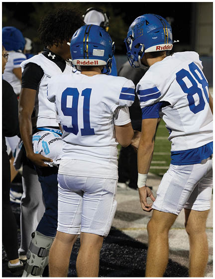 A football player wearing a blue jersey with the number 58 on it. Description generated by AI