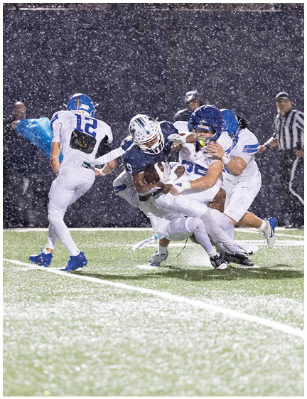 A football player wearing a blue jersey with the number 58 on it. Description generated by AI